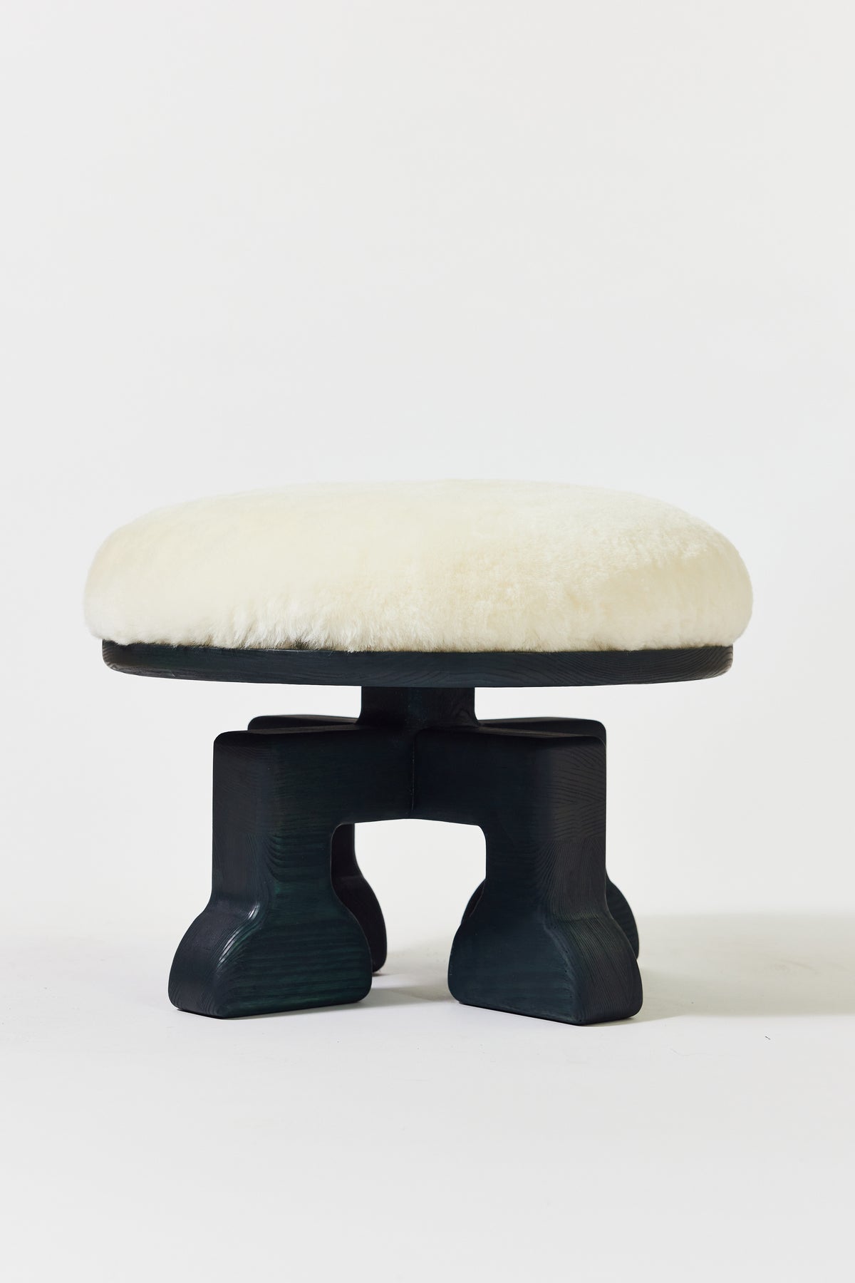 Muffin Man Stool in Midnight Green Ash with white shearling seat. Handmade solid wood stool with shearling seat by Phillip's Daughter