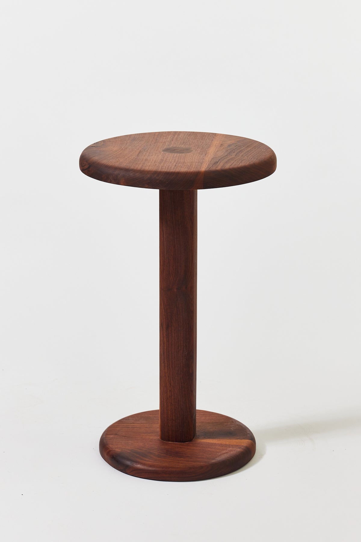Florian Side Table with large top in solid walnut, detail view 5. Handmade round wooden pedestal side table by Phillip's Daughter