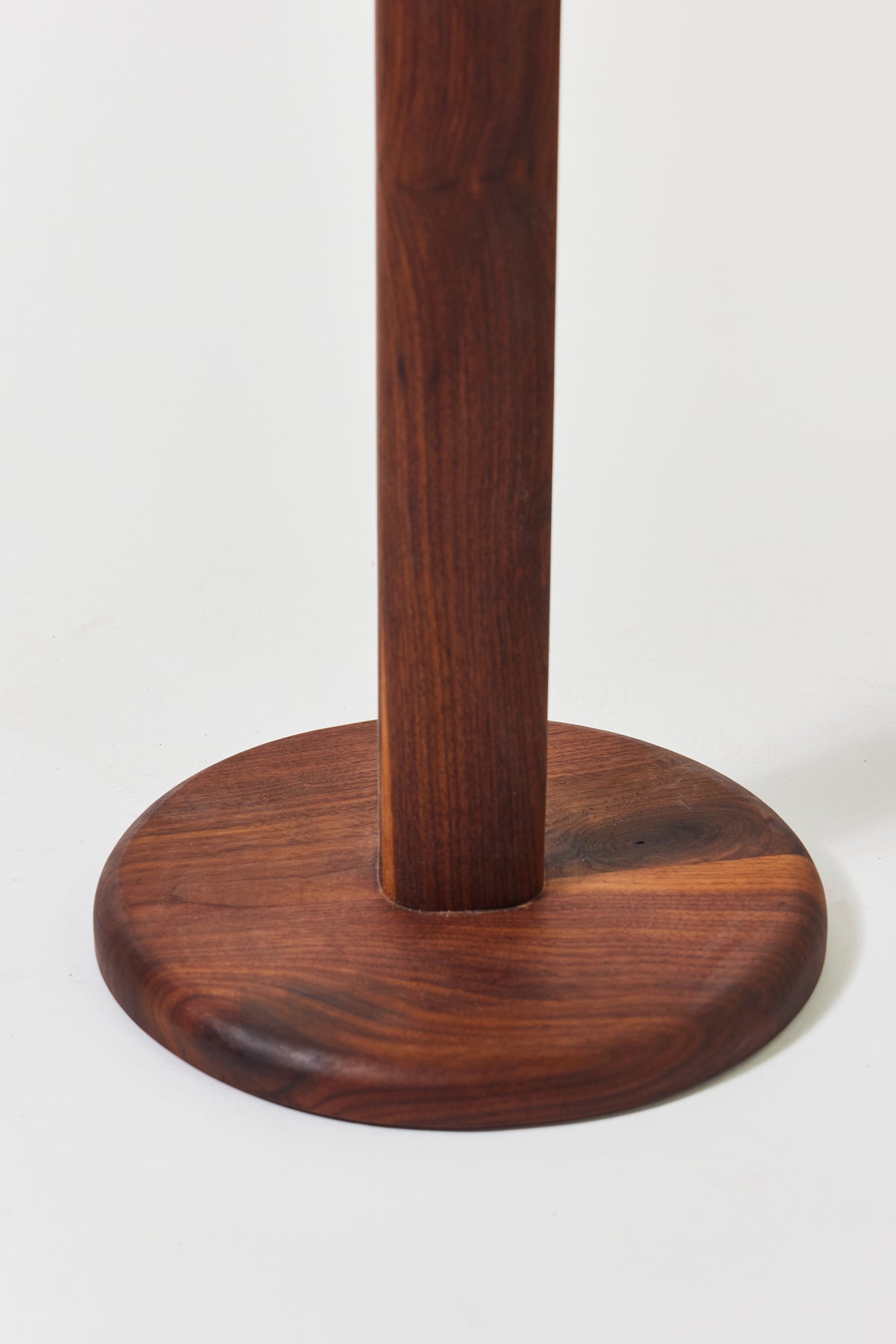 Florian Side Table with large top in solid walnut, detail view 4. Handmade round wooden pedestal side table by Phillip's Daughter