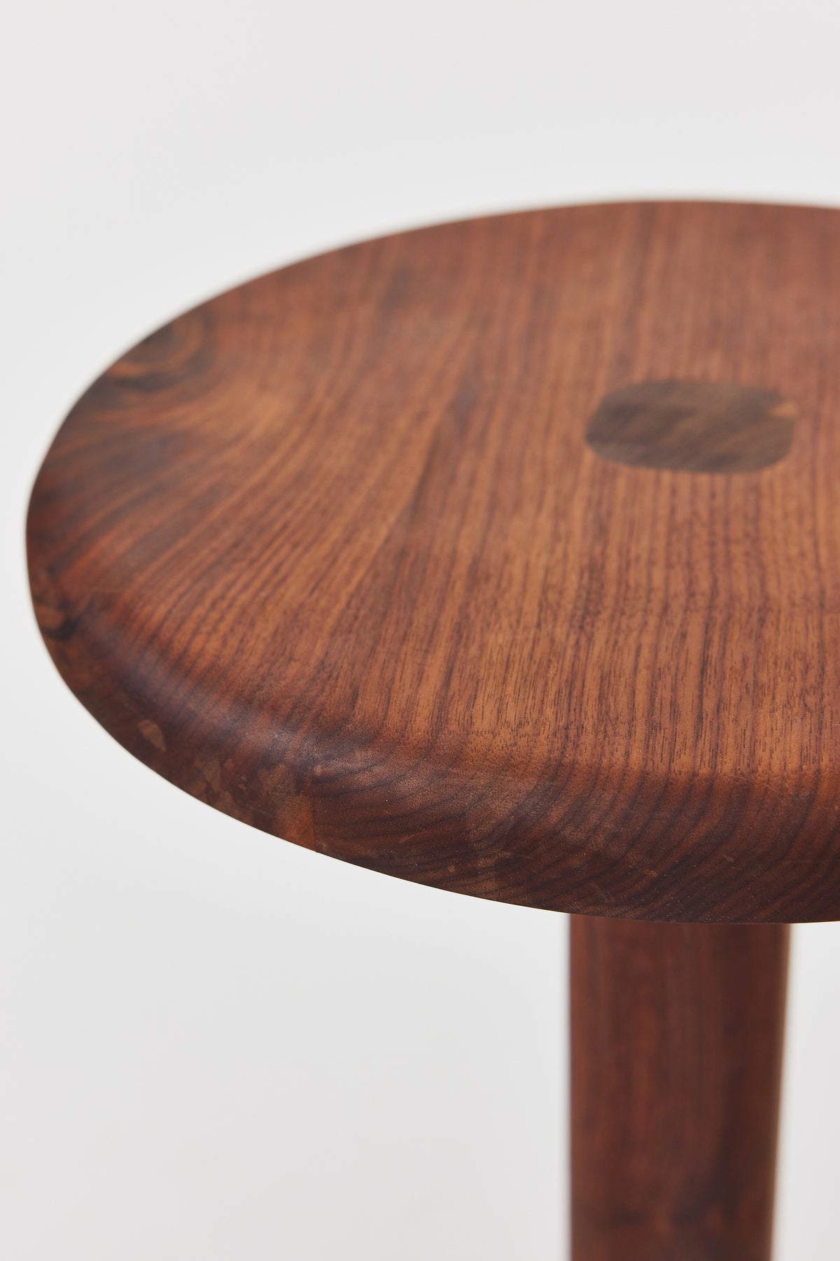Florian Side Table with large top in solid walnut, detail view 2. Handmade round wooden pedestal side table by Phillip's Daughter