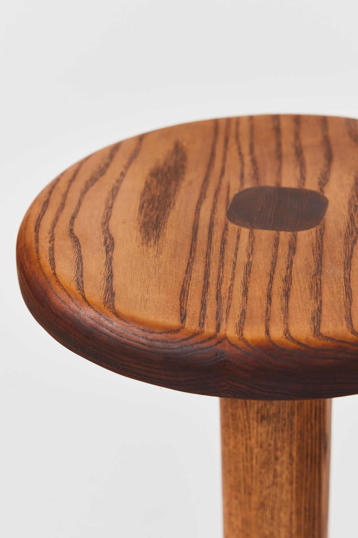 Florian Table with small top in Caramel Ash, detail view 3. Handmade round wooden pedestal side table by Phillip's Daughter