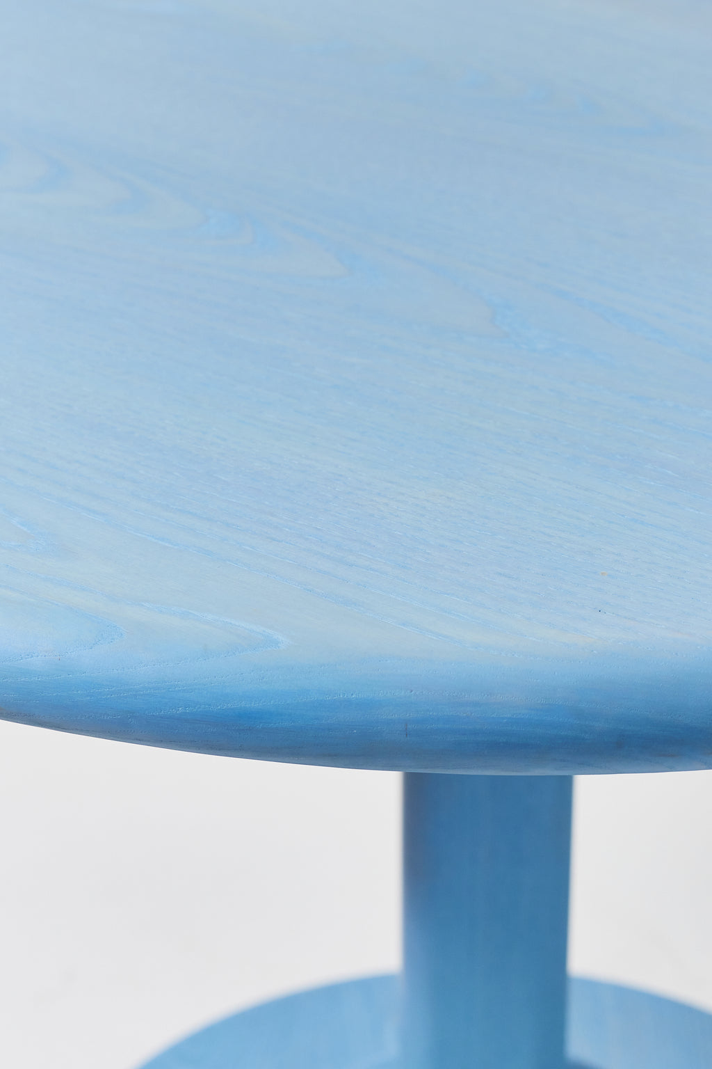 Gumdrop Pedestal Table in Light Blue Ash, detail view 2. Handmade 40 inch round solid ash pedestal dining table by Phillip's Daughter