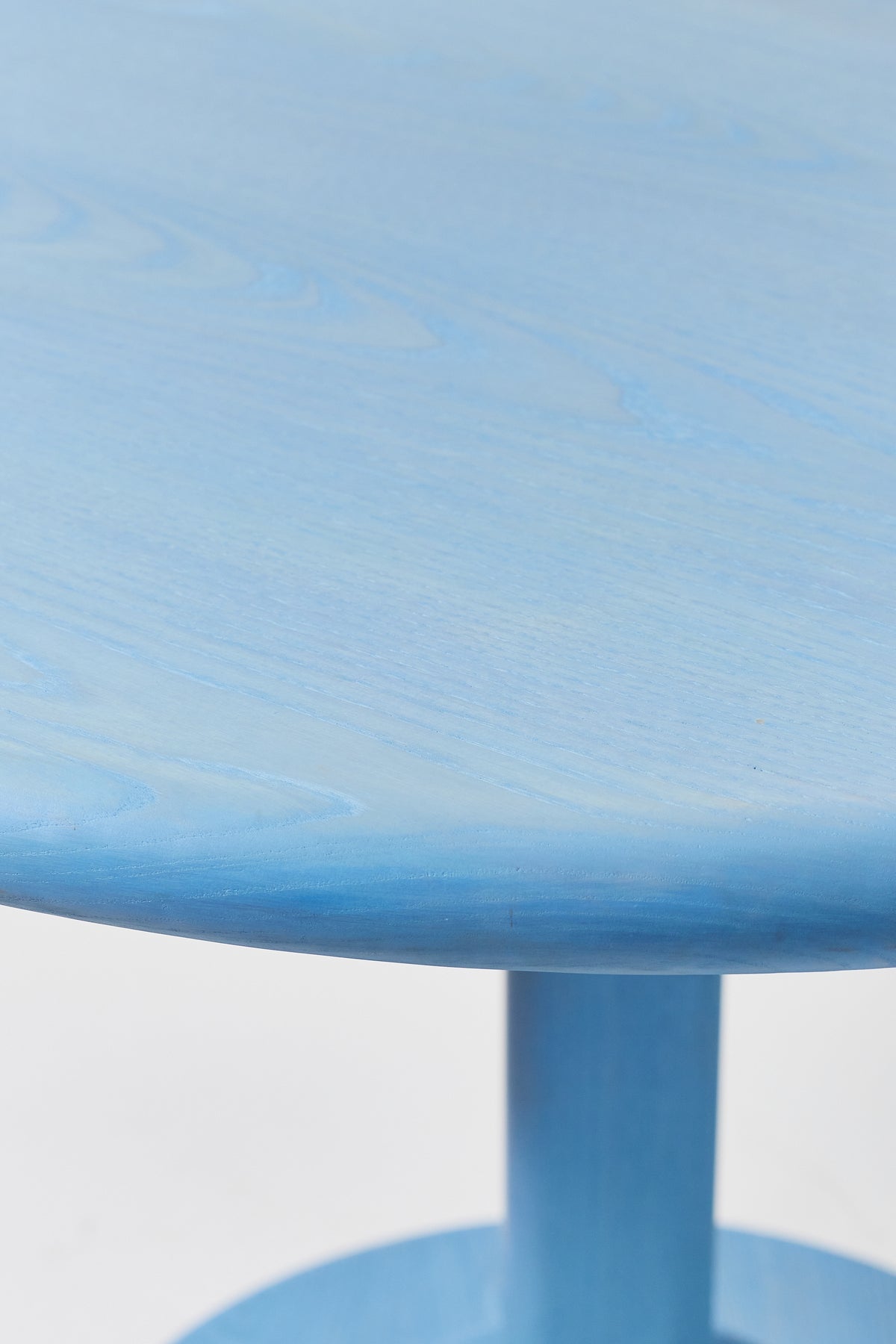 Gumdrop Pedestal Table in Light Blue Ash, detail view 2. Handmade 40 inch round solid ash pedestal dining table by Phillip's Daughter
