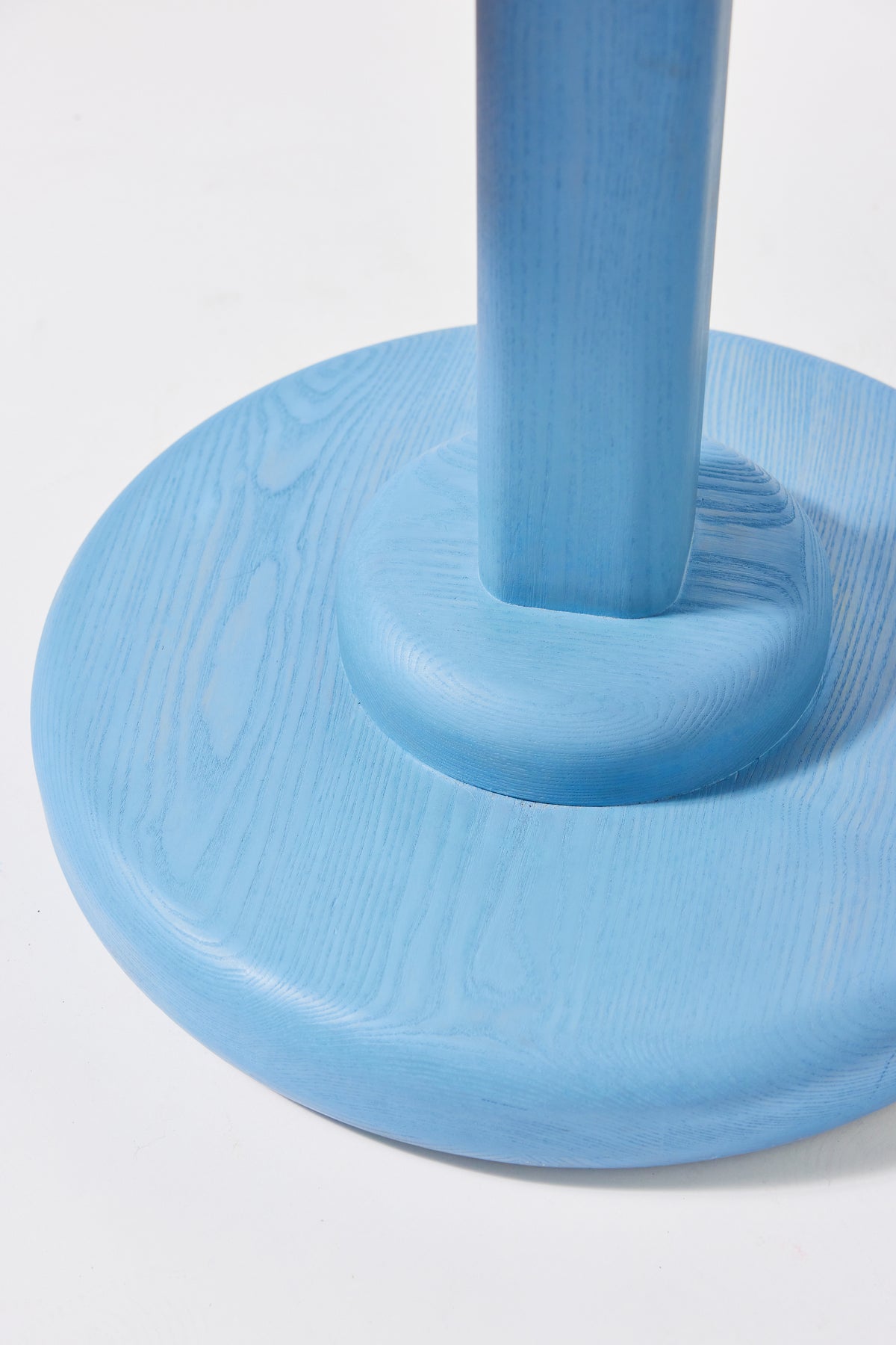 Gumdrop Pedestal Table in Light Blue Ash, detail view 4. Handmade 40 inch round solid ash pedestal dining table by Phillip's Daughter