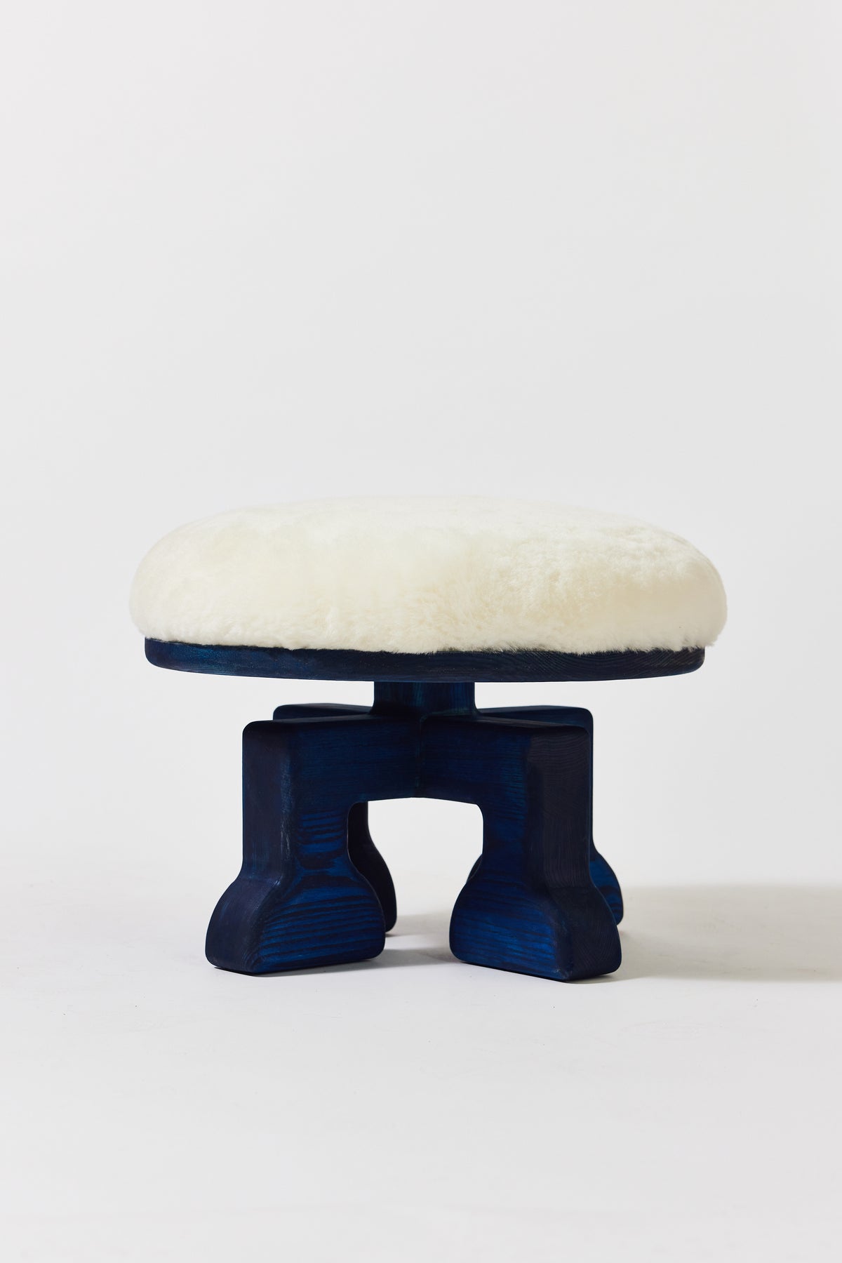 Muffin Man Stool in Navy Ash with white shearling seat. Handmade solid wood stool with shearling seat by Phillip's Daughter