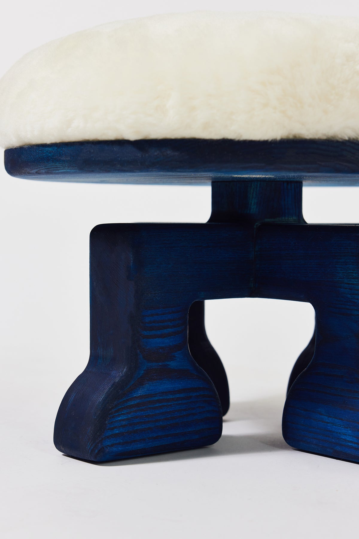 Muffin Man Stool in Navy Ash with white shearling seat, alternate view. Handmade solid wood stool with shearling seat by Phillip's Daughter