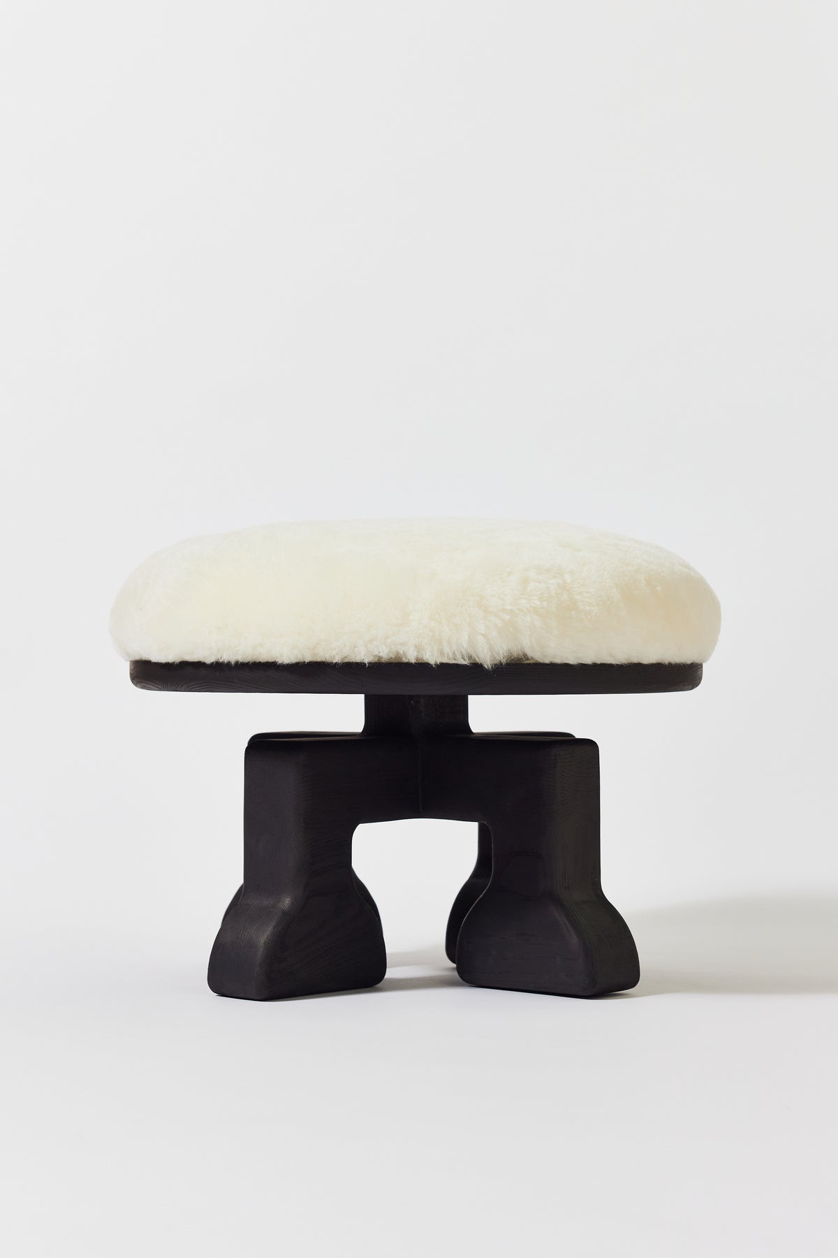 Muffin Man Stool in Black Ash with white shearling seat. Handmade solid wood stool with shearling seat by Phillip's Daughter