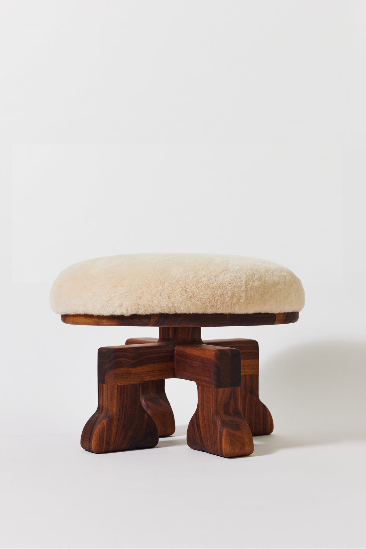 Muffin Man Stool in solid walnut with putty shearling seat. Handmade solid wood stool with shearling seat by Phillip's Daughter