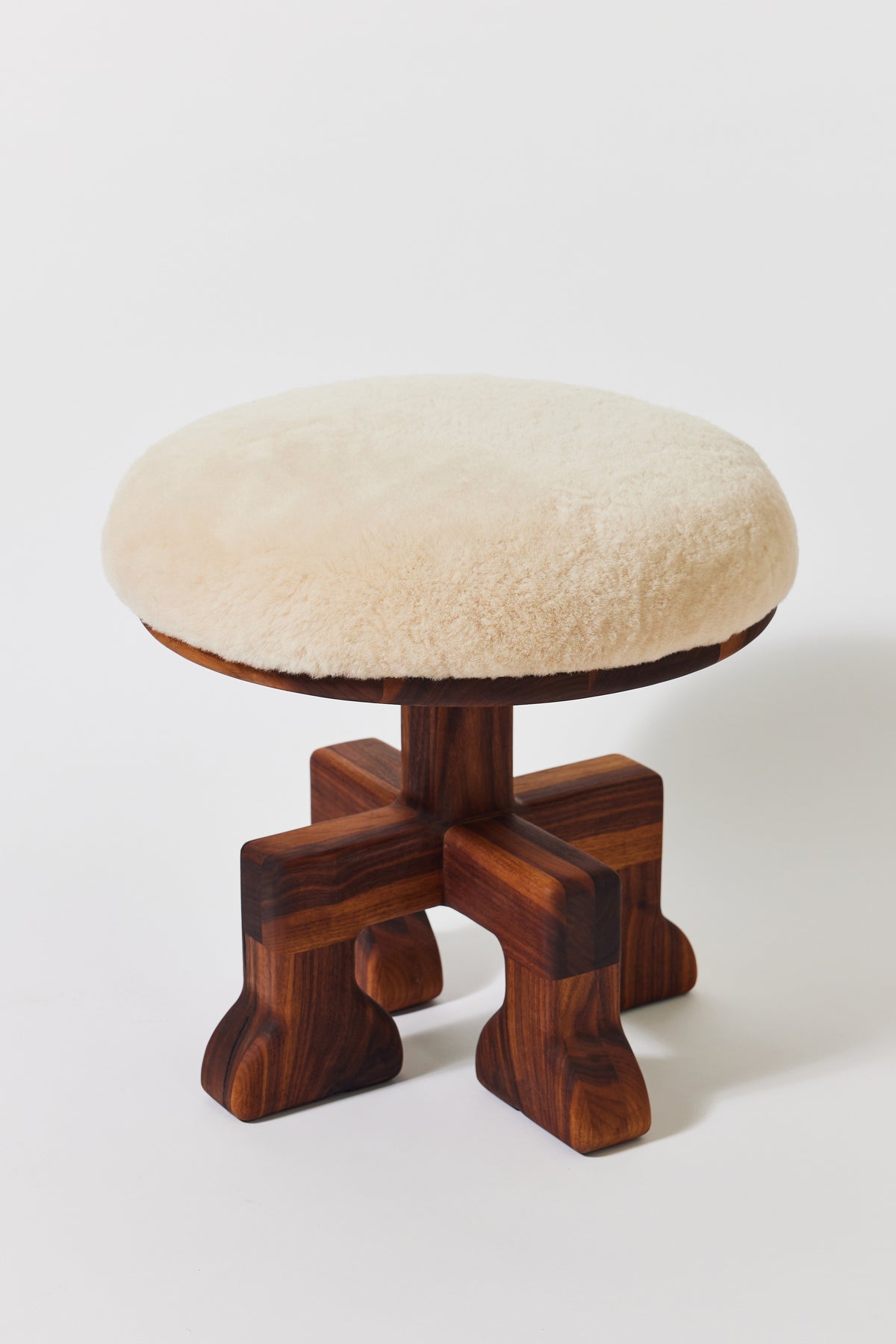 Muffin Man Tall stool in solid walnut with putty shearling seat, detail view 2. Handmade tall solid wood stool with shearling seat by Phillip's Daughter