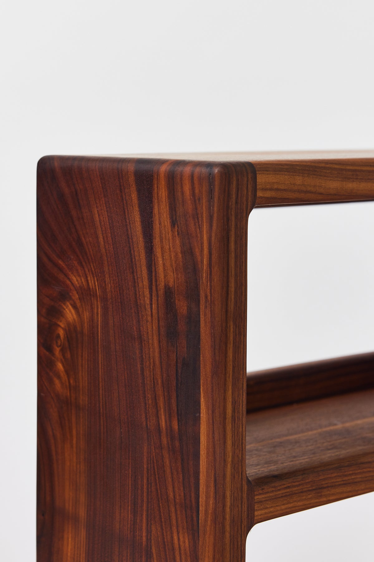 Julius Short Shelf in solid walnut, detail view 5. Handmade low wooden bookshelf by Phillip's Daughter