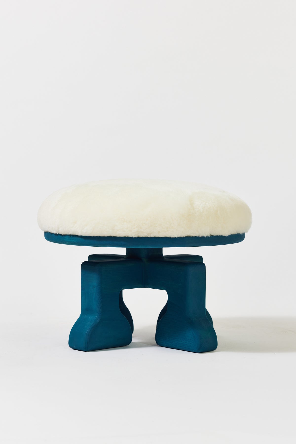 Muffin Man Stool in Peacock Blue Ash with white shearling seat. Handmade solid wood stool with shearling seat by Phillip's Daughter