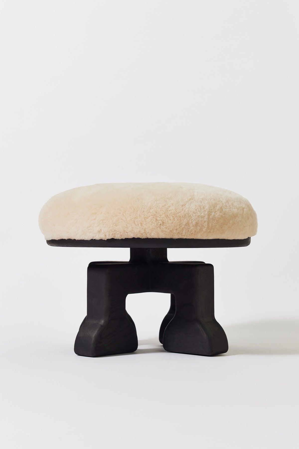 Muffin Man Stool in Black Ash with putty shearling seat. Handmade solid wood stool with shearling seat by Phillip's Daughter