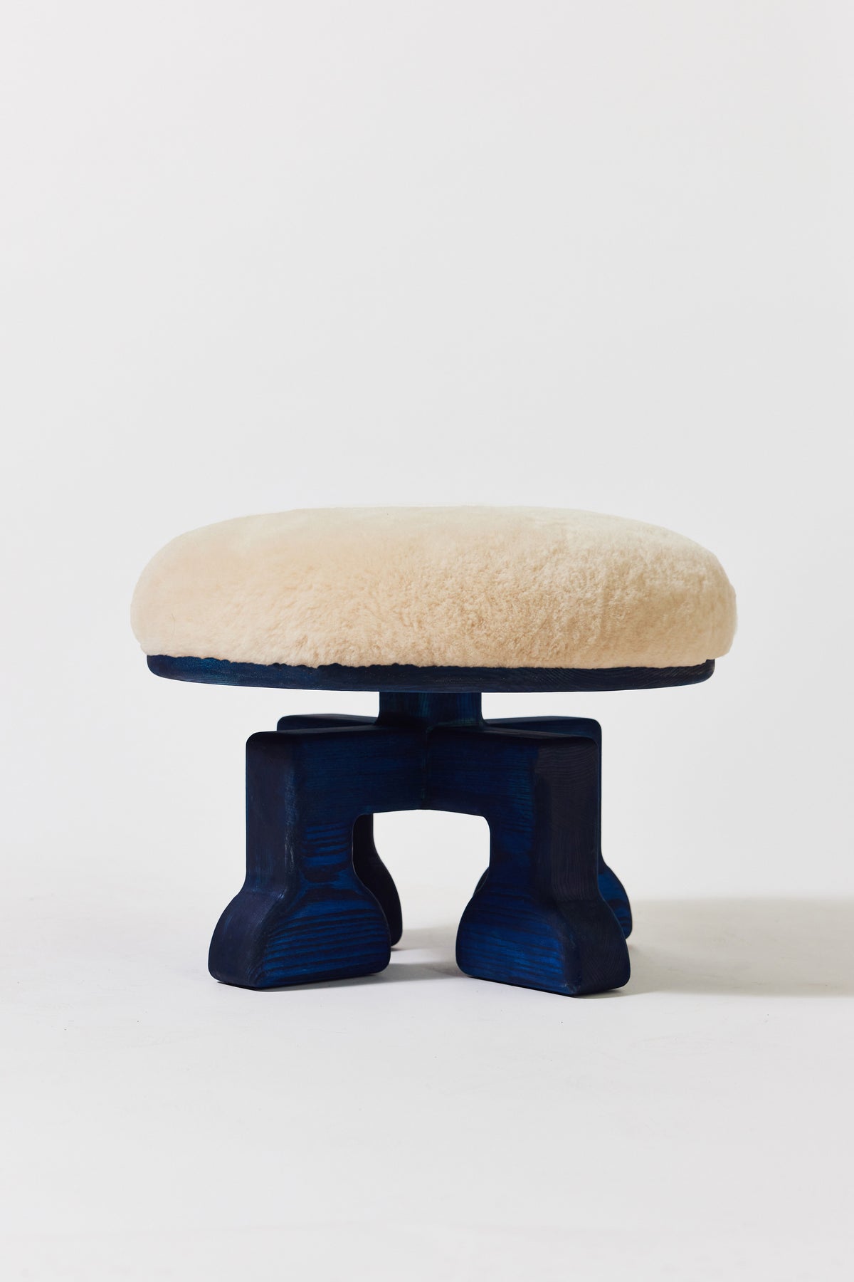 Muffin Man Stool in Navy Ash with putty shearling seat. Handmade solid wood stool with shearling seat by Phillip's Daughter