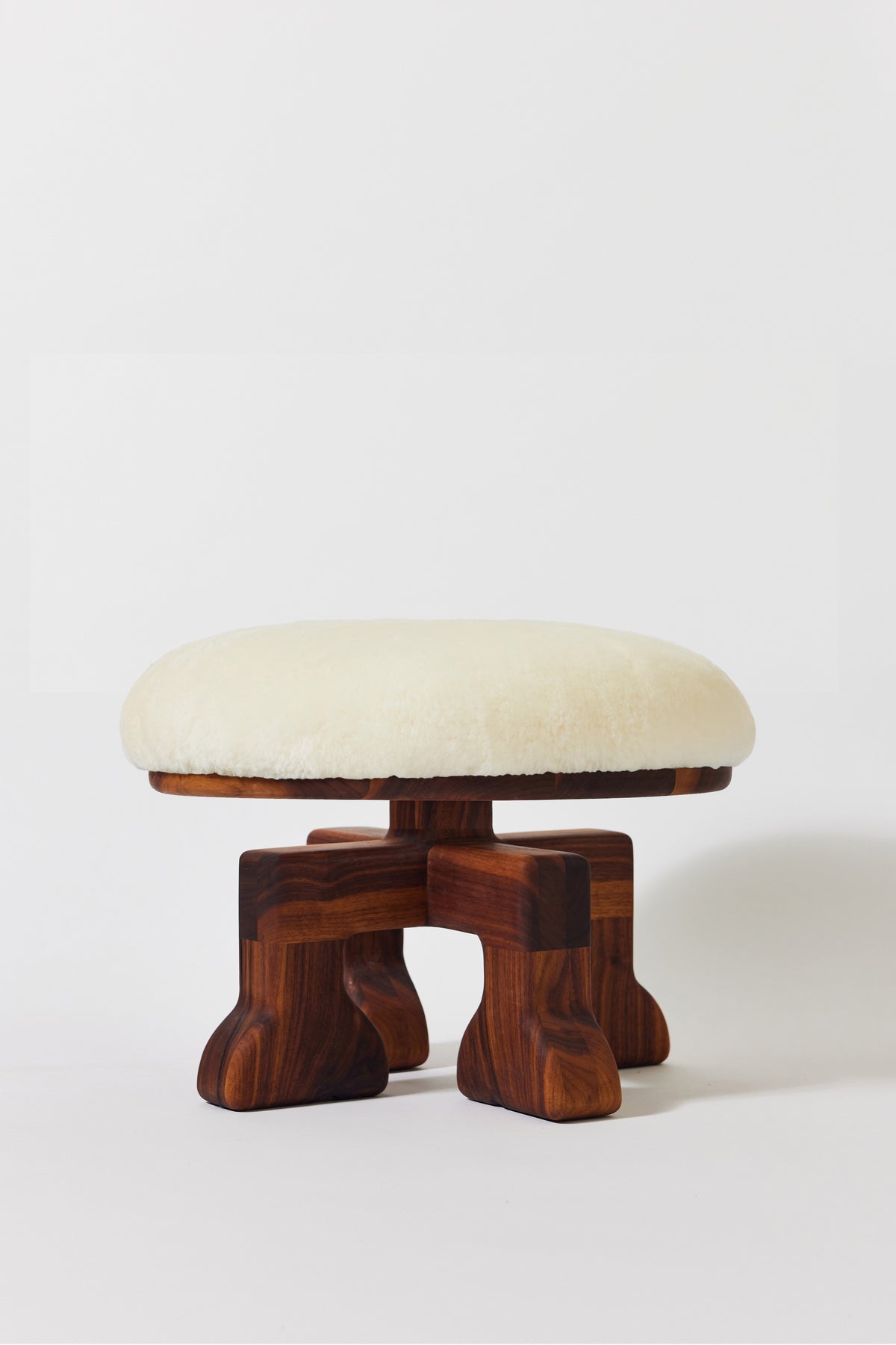 Muffin Man Stool in solid walnut with white shearling seat. Handmade solid wood stool with shearling seat by Phillip's Daughter